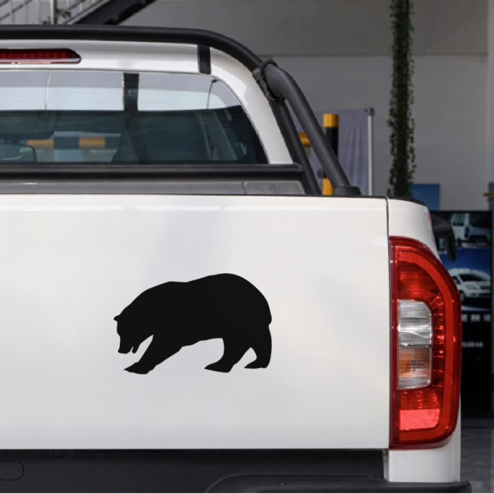 Lumbering Bear sticker on a pickup tailgate