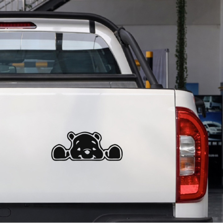 Peeking Bear sticker on a pickup tailgate