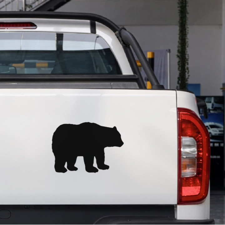 Shaggy Black Bear sticker on a pickup tailgate